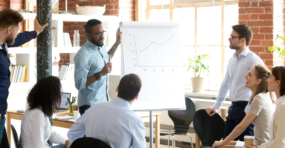 Employees meet over a business growth chart